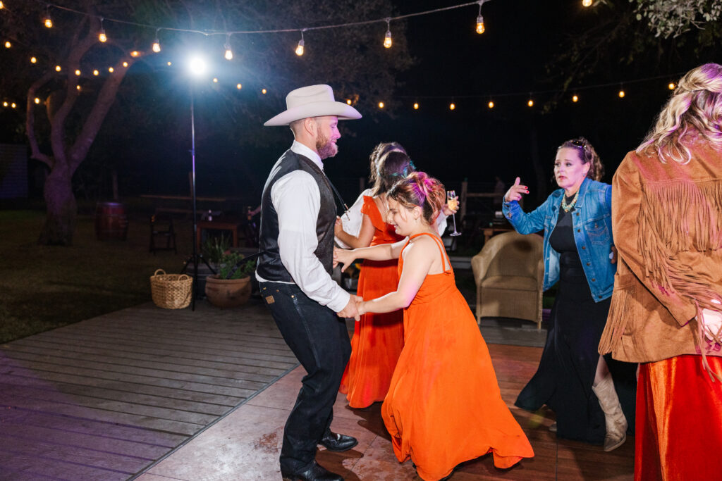 San Antonio groom dances with a flower girl before him and his San Antonio bride exit for their wedding night -tips