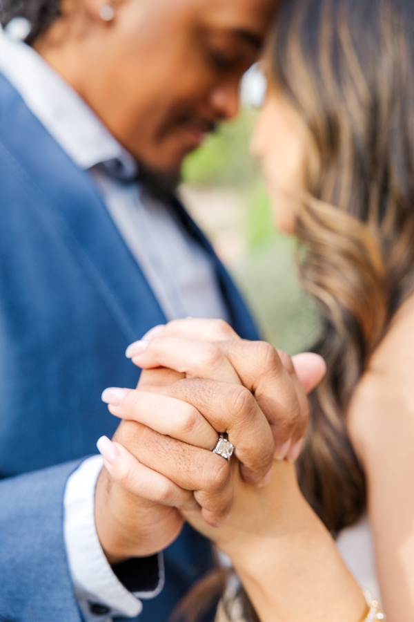 In this San Antonio engagement photo, the bride to be shows off her ring holding the hand of her fiancé. Their faces are blurred as the camera is focused on their hands