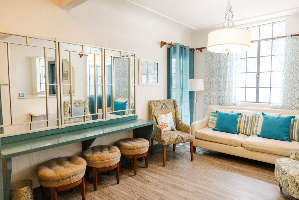 Bridal getting ready room at the Veranda San Antonio wedding venue. 3 spots to sit at the giant vanity. A couch and a couple chairs.