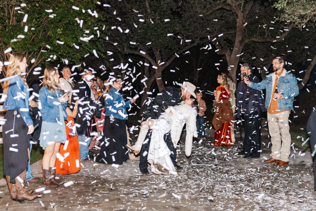 Weeding night tips - do your San Antonio wedding exit with your guests throwing confetti. Do a dip like this couple for a beautiful picture