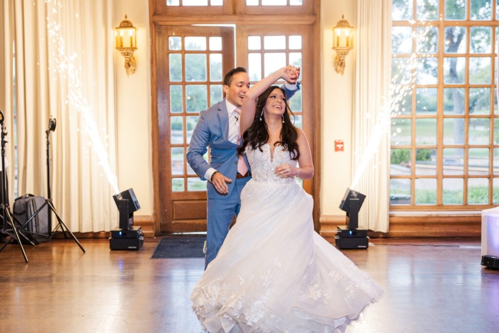 Groom spins bride during the first dance at a San Antonio wedding venue