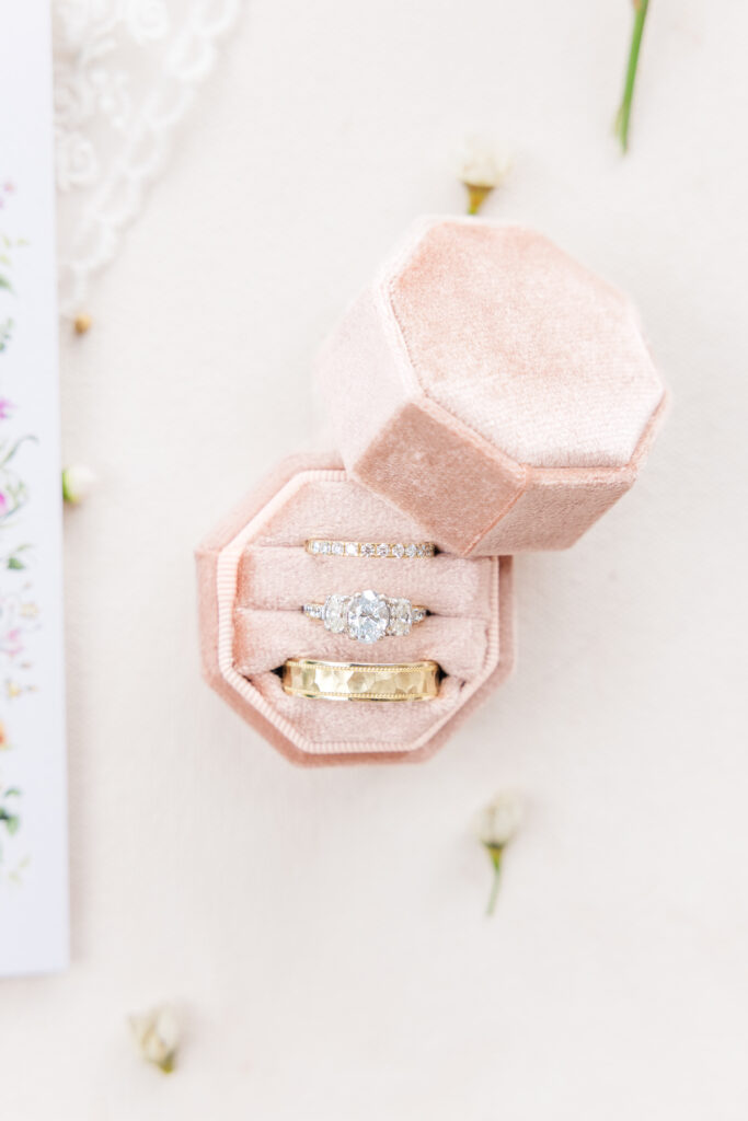 San Antonio wedding photographer captures close up photo of a ring box with an engagement ring, wedding band, and another band inside. 