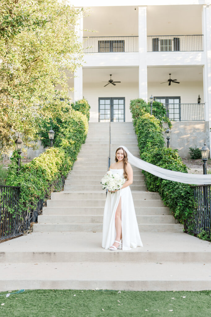 San Antonio bride poses in front of Kendall Point wedding venue